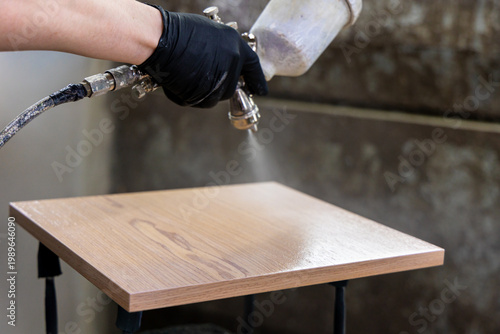 Canvas-taulu Spraying Wood Surface with Paint Gun Furniture Finishing Process