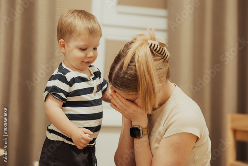 Mother overwhelmed by toddler at home, emotional parenting moment, stress and family life concept