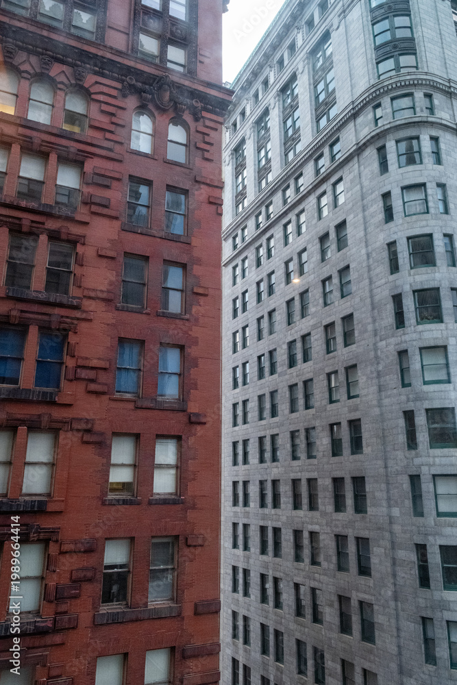Fototapeta premium Views of Historic Buildings on a Street in Downtown Pittsburgh During the Day With Contrasting Architecture Styles