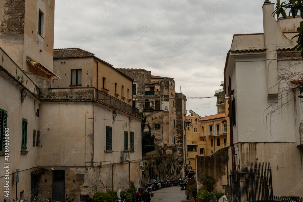 Obraz premium Scenic inland Amalfi town street in springtime under heavily overcast sky, Amalfi Coast, Campania, Southern Italy