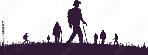 Hikers trekking group on grassy hill with mountains in distance silhouette.