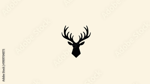 Minimalist black deer head silhouette with majestic antlers on a simple light beige background. Elegant stag icon design.