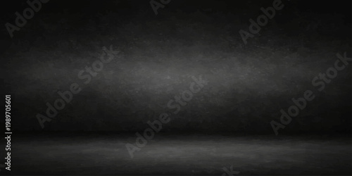 An empty dark room interior features a dirty vintage concrete wall with a gray grunge texture and aged blackboard surface design for a blank industrial backdrop