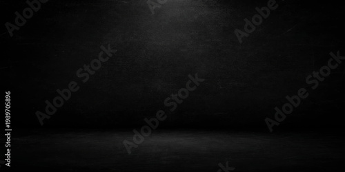 Aged dark concrete wall texture with a vintage black grunge pattern creates a blank grey stone backdrop for an empty textured room surface