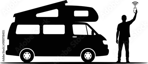 A man searching network near his camper van silhouette.