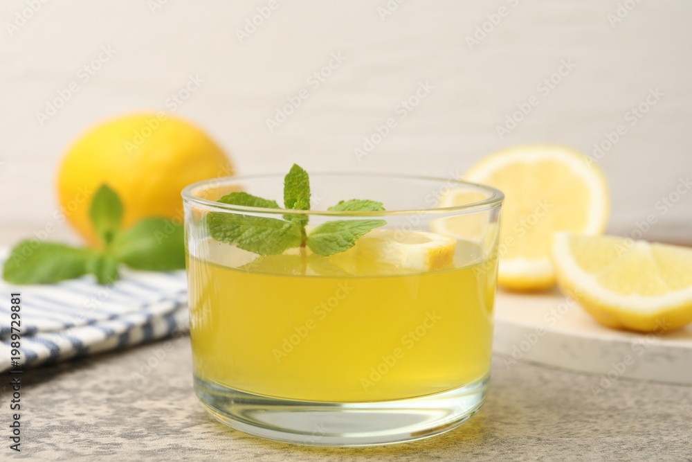 Fototapeta premium Tasty lemon jelly served with mint on light grey table, closeup