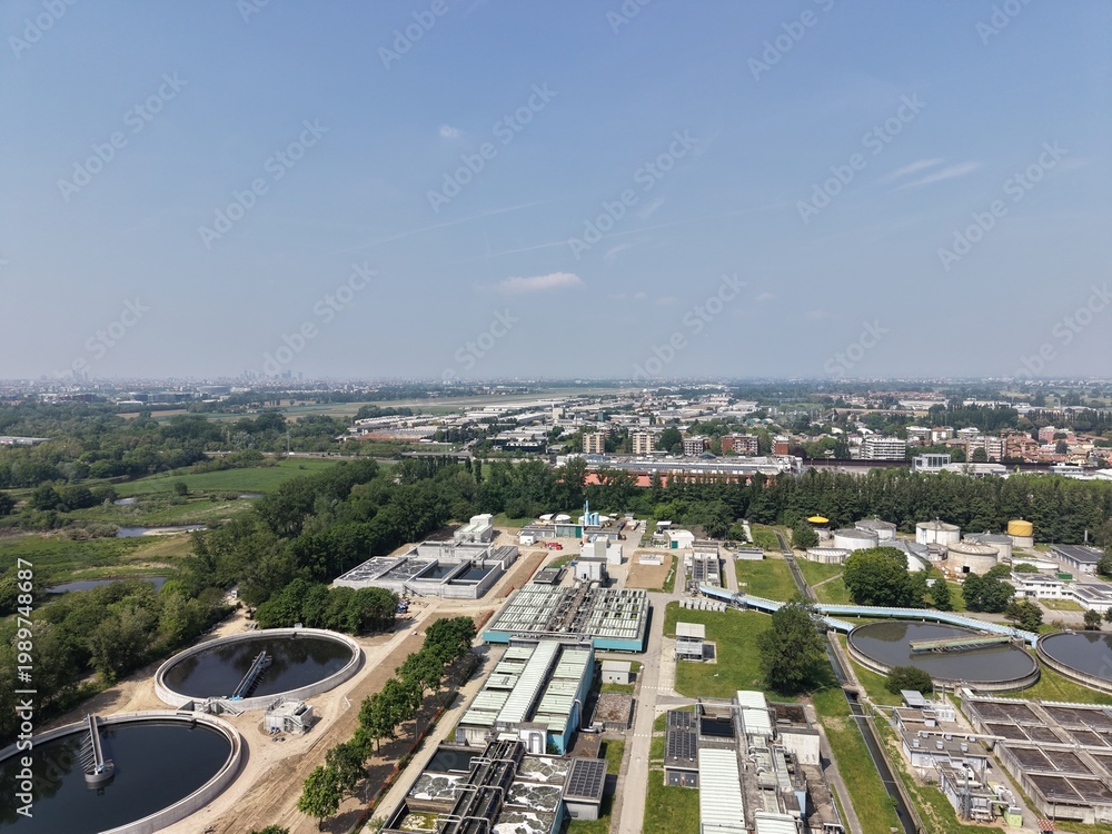 Fototapeta premium Aerial View of Wastewater Treatment Facility: An expansive aerial perspective captures a wastewater treatment facility amidst nature.