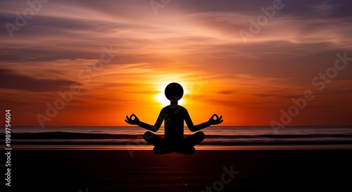 Silhouette figure practices meditation pose against dramatic ocean sunset