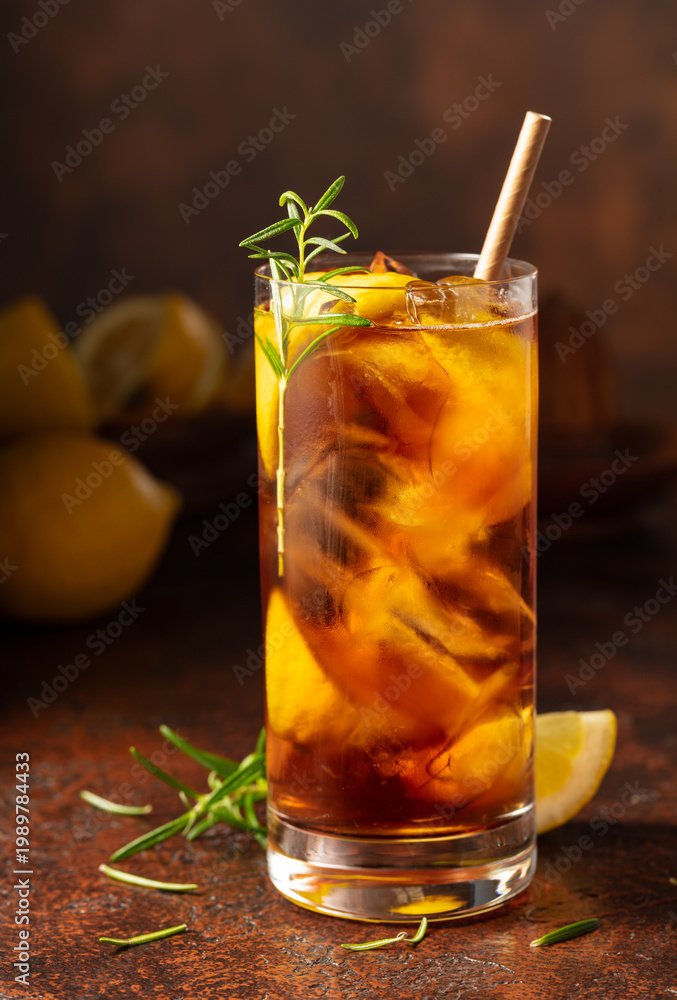 Fototapeta premium Iced tea or cocktail with ice, rosemary and lemon slices.