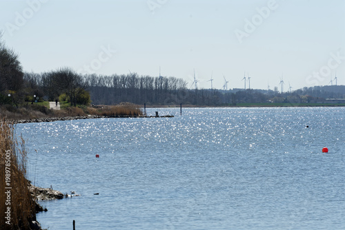 Germany, Mecklenburg Vorpommern, Rerik, April 8, 2026: Rerik Ostsee Baltic Sea coastline with sparkling water and wind turbines