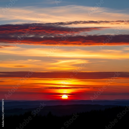 Vibrant sunset over the horizon with colorful clouds.