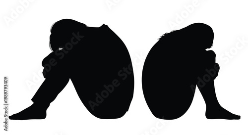 Two people sitting with heads down in a dark silhouette