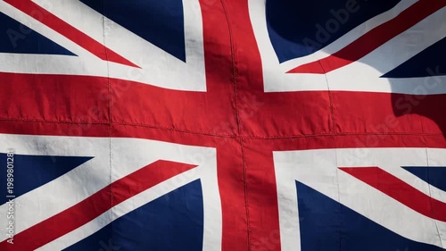 United kingdom flag waving in the wind with a clear blue sky