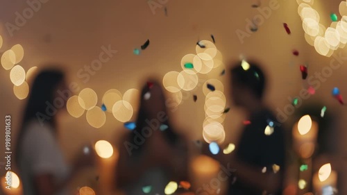 Blurry image of people celebrating with confetti and lights