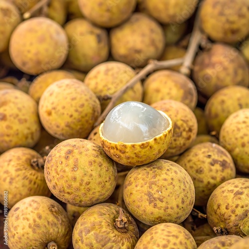 Longan fruit pile; one half shows the translucent white flesh