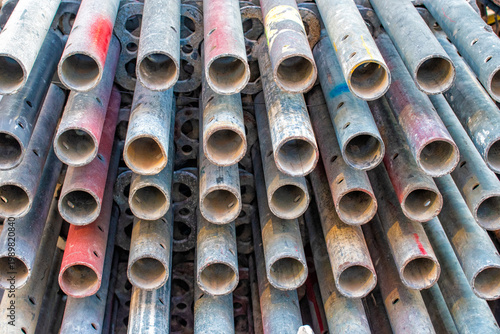 disassembled and stacked scaffolding tubes creating a pattern