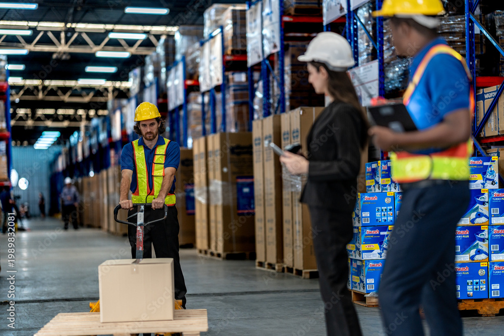 Fototapeta premium Professional logistics team managing supply chain operations. Warehouse staff using digital tablets and pallet jacks to streamline inventory movement and shipping processes.