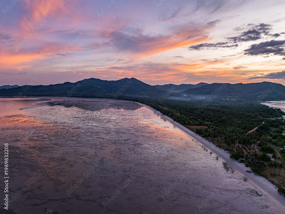 Obraz premium Aerial view of A Peaceful Glow Before the Night. The sky shimmers in gentle hues just before darkness falls, wrapping the horizon in a peaceful glow that feels timeless and pure.