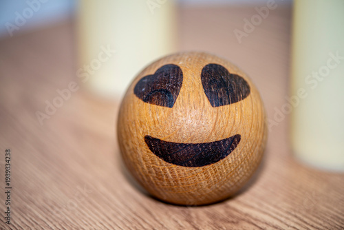 Wooden smiley face with heart eyes