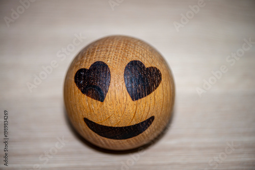 Wooden smiley face with heart eyes