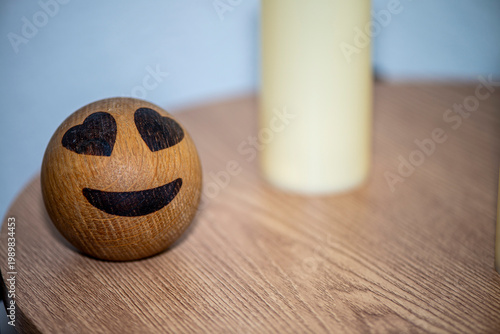 Wooden smiley face with heart eyes