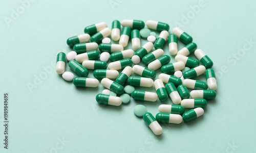 image captures green white capsules forming brain silhouette soft background conveying