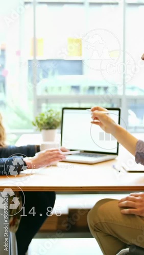 Right man offering pen, woman reaching keys while icons on laptop showing business data for meeting