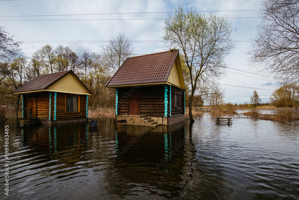 Fototapeta premium Flooded wooden rural houses. Concept of natural disaster