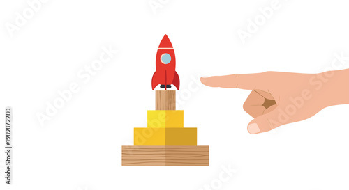 A clean human hand points toward a minimalist red rocket ship standing on a structured pedestal of bright yellow cubes and natural wooden base blocks.