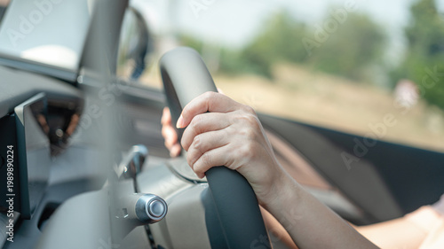 Cuadro en lienzo Action of a driver is gripping on steering wheel to control the car during driving