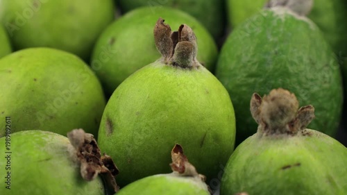 Green feijoa fruit circle rotation close up