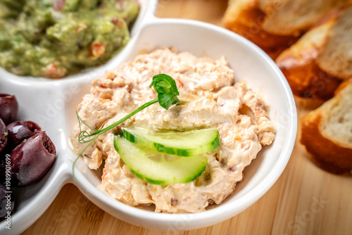 Creamy tuna salad dip with cucumber garnish