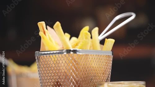 French fries dipping into ketchup close up, crispy fast food scene, copy space