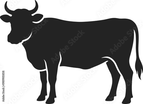 Black silhouette of a cow standing with head turned