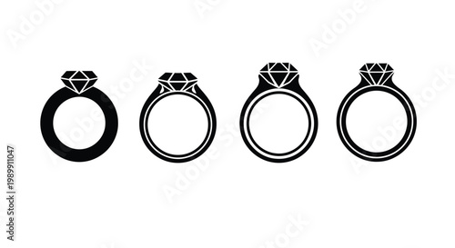 Four engagement rings displayed in a stark black silhouette