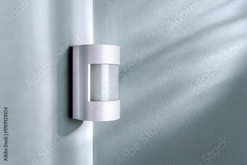Modern white motion sensor light mounted on a textured blue wall with soft light and shadow patterns.