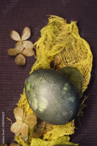 Natural Easter decoration with dried petals, colored egg