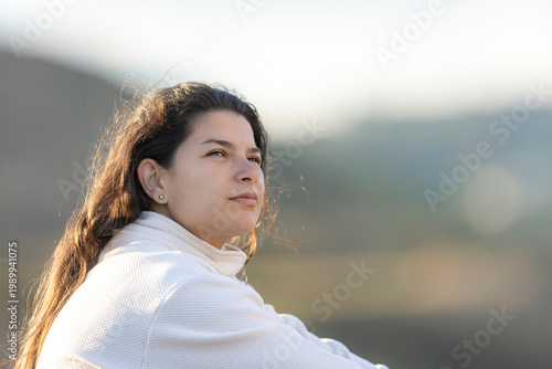 Tableau sur toile Young woman contemplating sunrise outdoors enjoying serenity