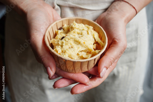 Holding a kulich mold with raw dough