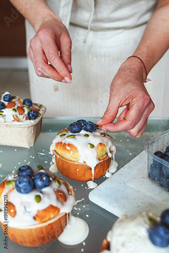 Easter cake decorating with cream, berries, and seeds