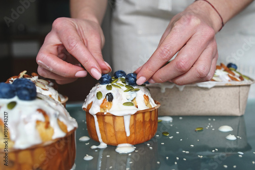Easter cake decorating with cream, berries, and seeds