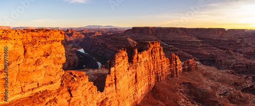 This scenic sunset panorama of Canyonlands National Park features glowing fins and the Colorado River surrounded by breathtaking scenery.