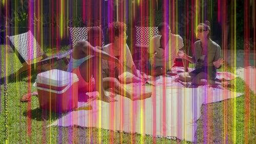 Four adults making lifestyle clip on picnic, frames advancing sparking color streaks covering scene