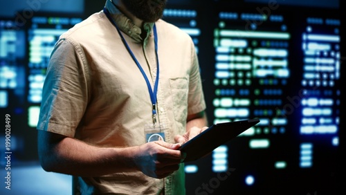 Quadro su tela Experienced engineer inspecting operational server racks in computer network security data center