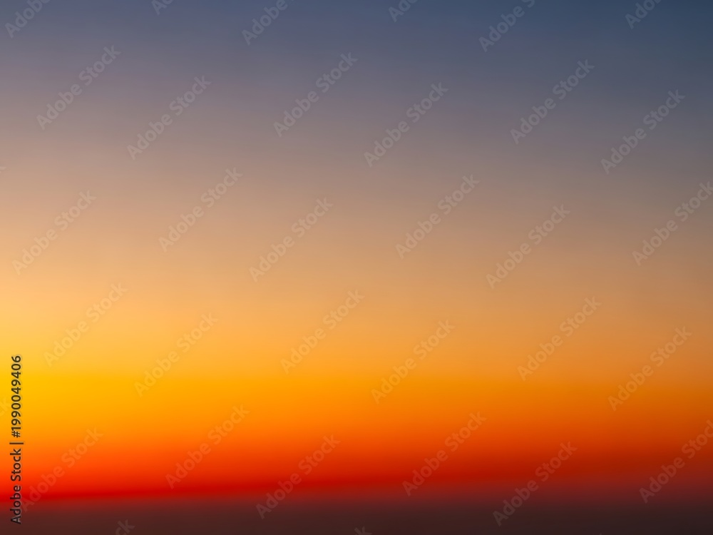 Fototapeta premium Vibrant Sunset Sky Orange, Yellow, and Blue Gradient Background, Peaceful Nature