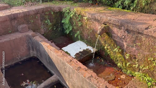 Beautiful 4K view of the sacred Gaumukh at Karhateshwar Temple, Ratnagiri Konkan, where crystal-clear water flows through ancient stone carvings amid serene coastal greenery and divine peace.
