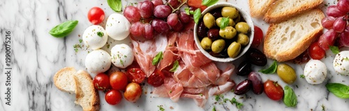Assorted antipasti platter featuring cheese, cherry tomatoes, olives, cured meats, and bread on a marble surface