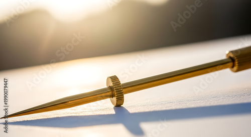 Precision calibrated golden instrument tip with intricate serrations and adjustable collar, catching warm sunlight for a detailed macro shot, emphasizing craftsmanship and fine detail