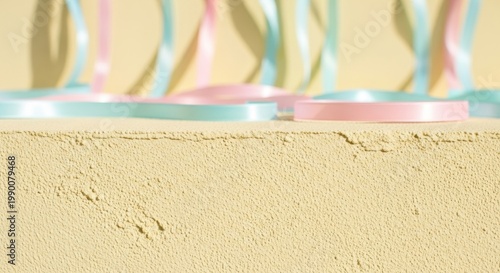 Soft Yellow Plaster Texture with Delicate Pastel Ribbons in Soft Focus