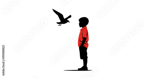 Silhouette of a boy in a red shirt watching a bird in flight
